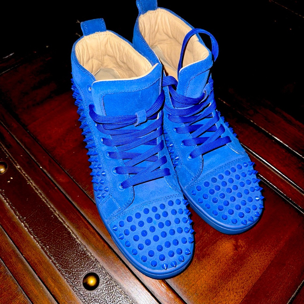 Used Christian Louboutin high top shoes .